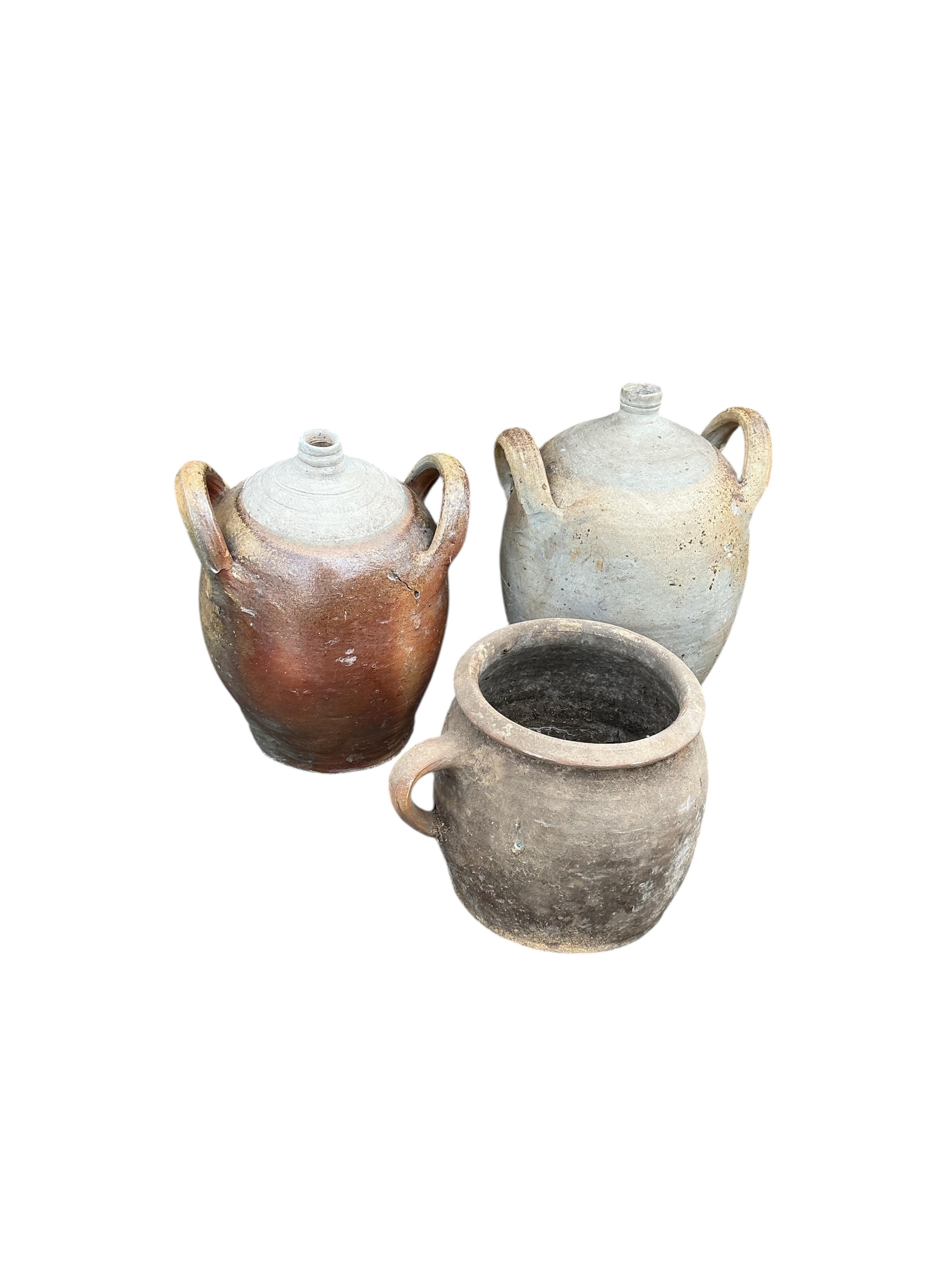 Nine earthenware containers, largest height 41cm